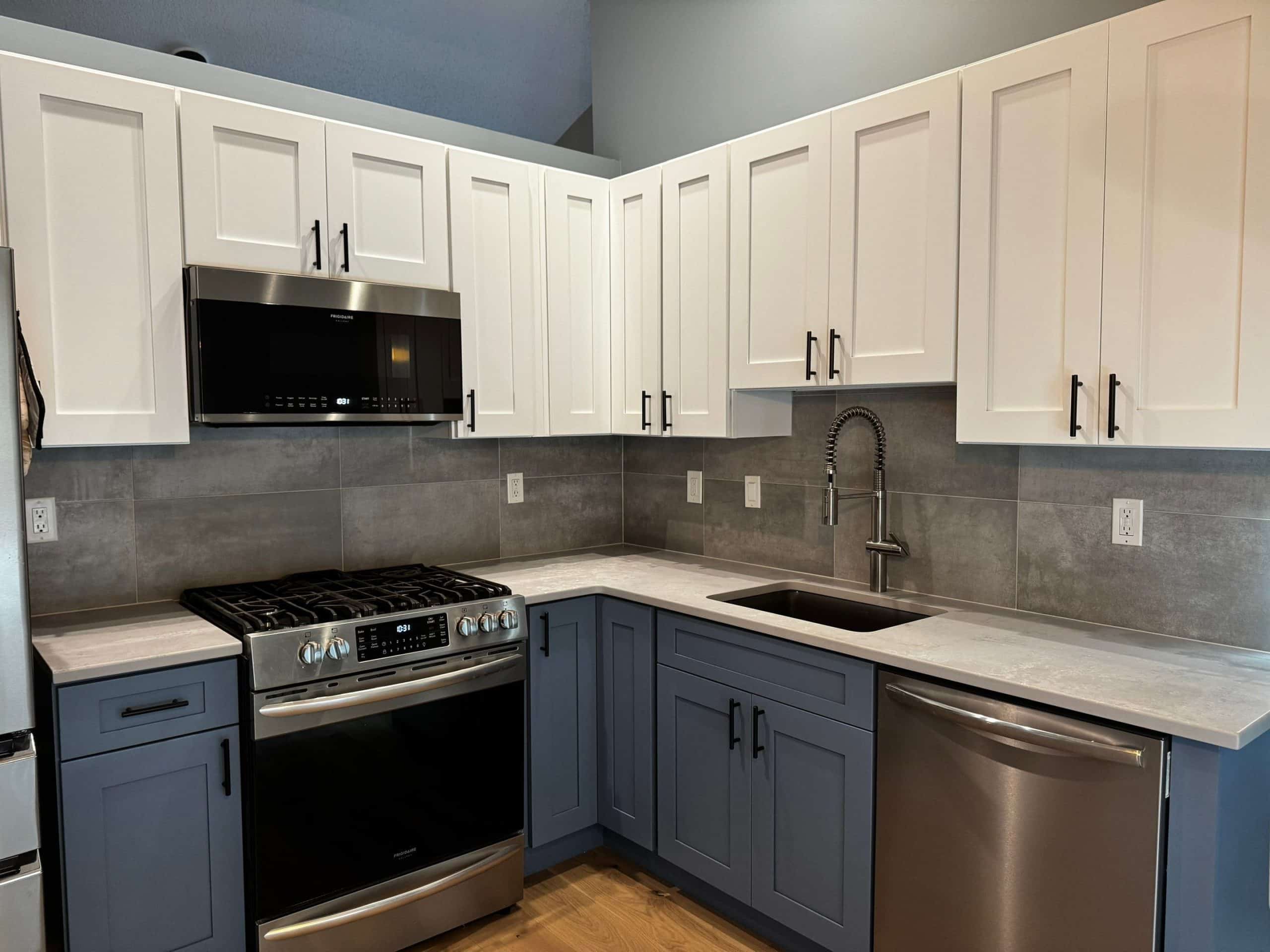 gray large tile backsplash in kitchen installation