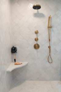A shower with diagonal tile pattern wall.