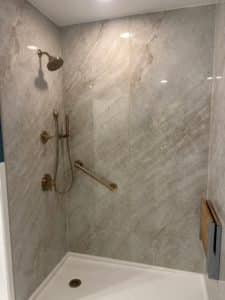 porcelain slab panel shower white marble with gold hardware