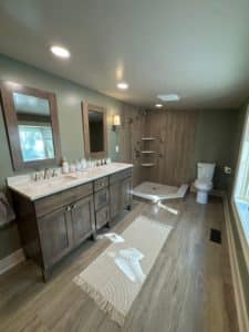 full bathroom remodel with unique brown panel tiles in standing shower